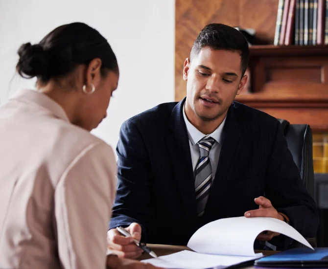 An attorney explains federal regulations, UETA and E-SIGN Act, to a client and shows a list of legal documents where electronic signatures are not applicable and require traditional signatures to be valid.